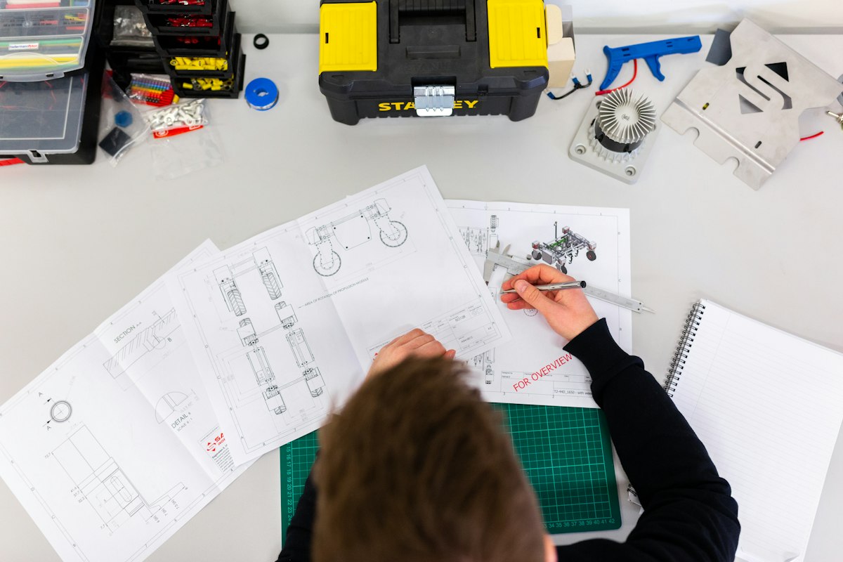 Toolbox and engineering drawings on a workbench